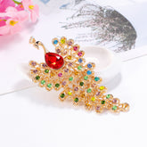 Colorful gemstone brooch with a red gem on a white surface with flowers in the background
