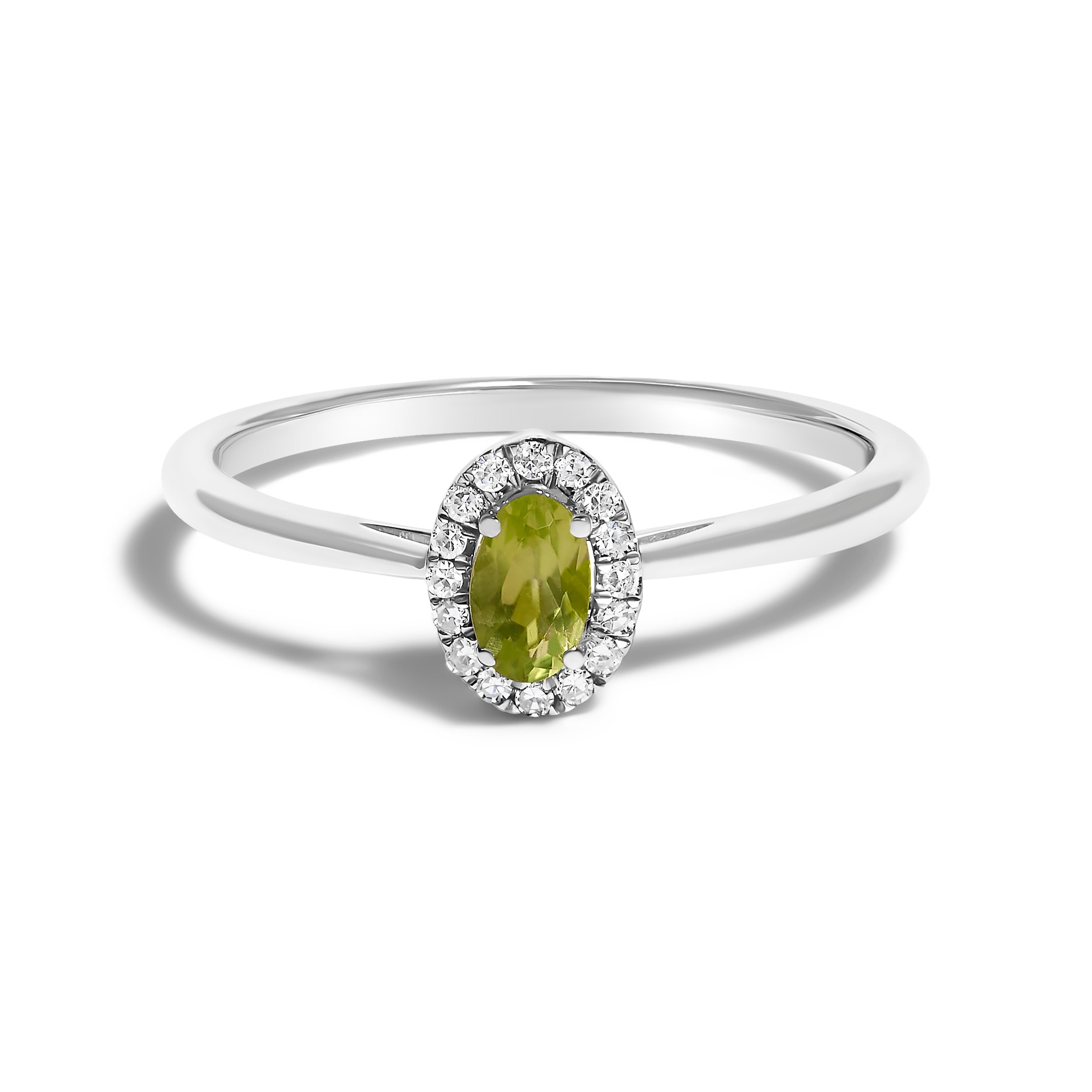 Silver ring with a green gemstone and diamond halo on a white background