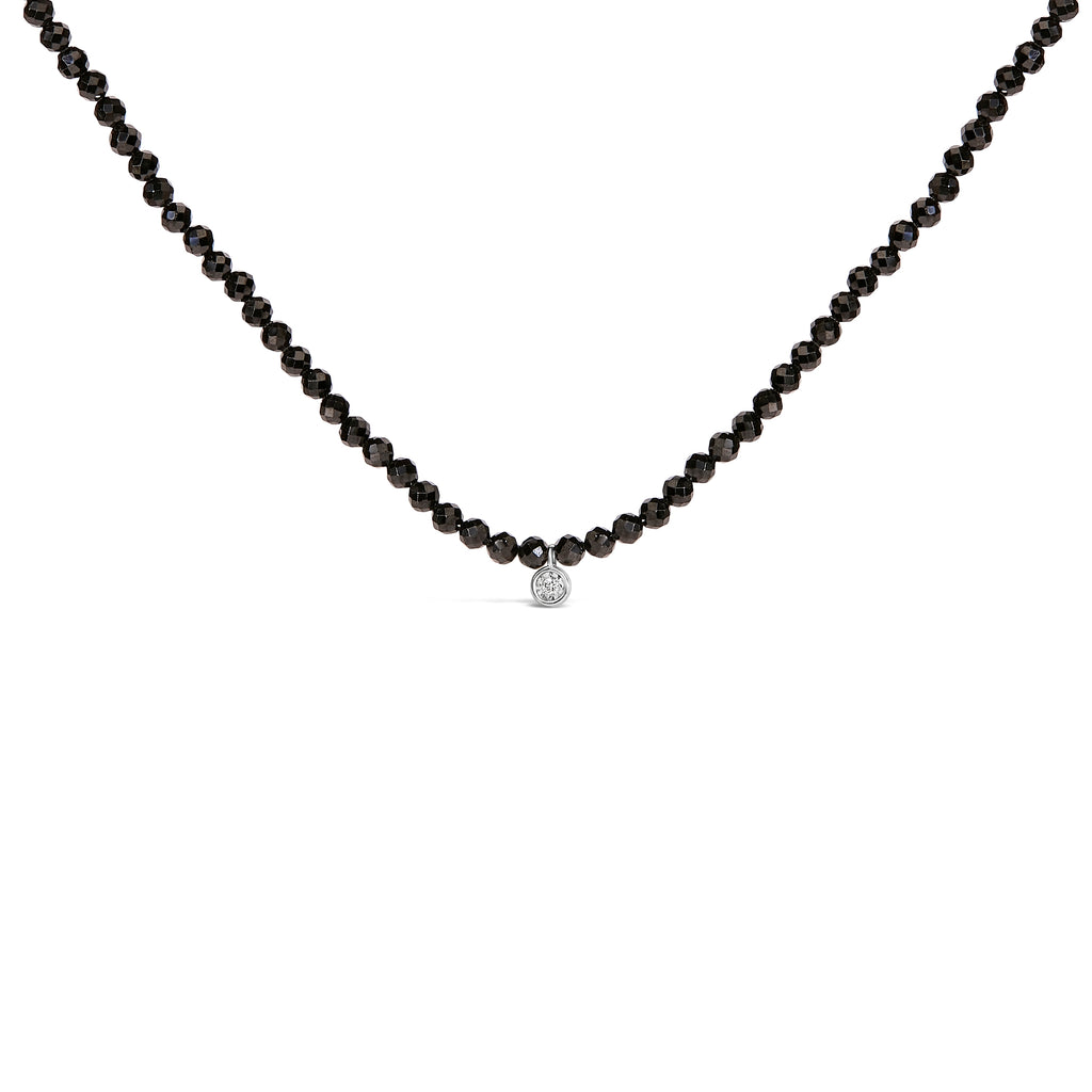 Black beaded necklace with a silver clasp on a white background
