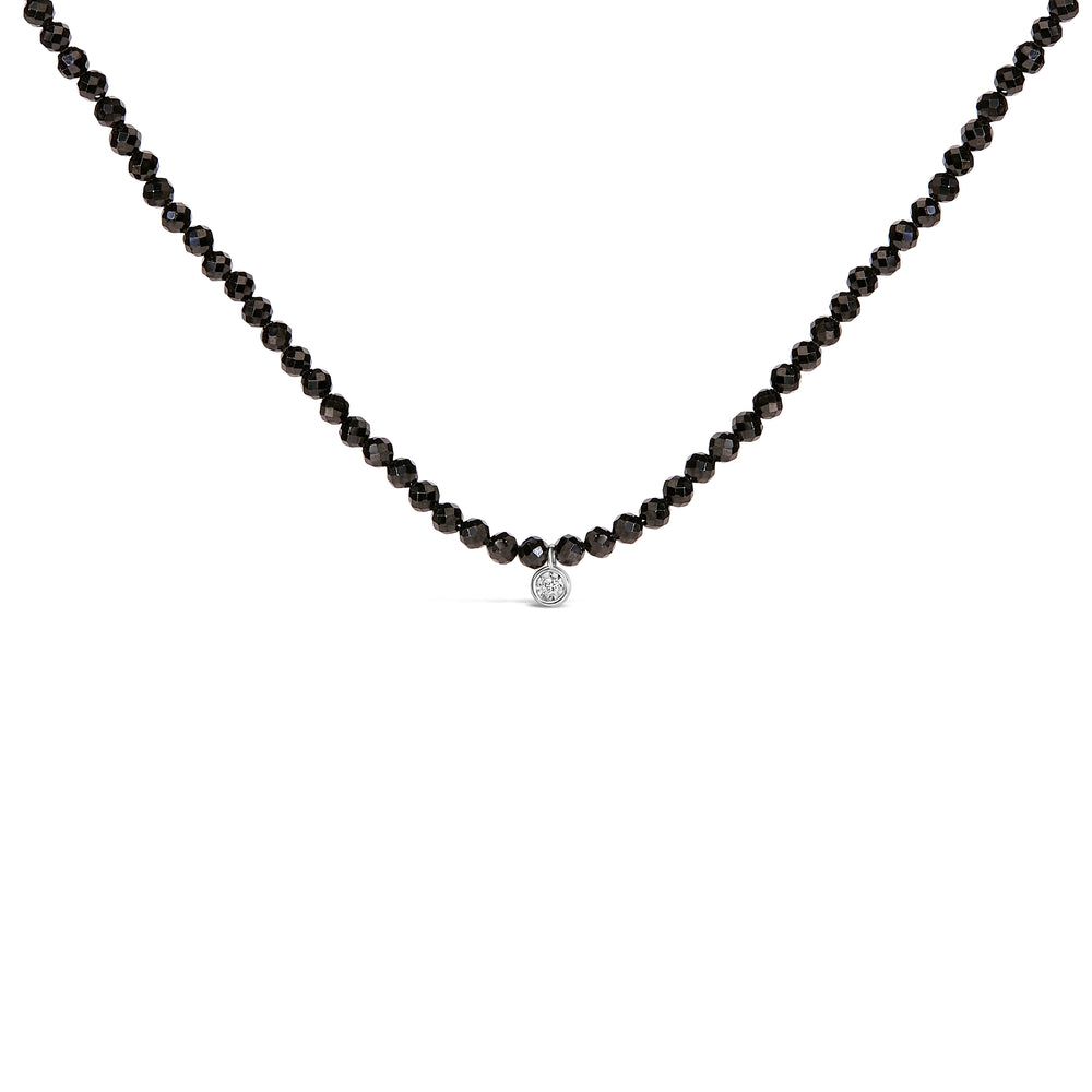Black beaded necklace with a silver clasp on a white background