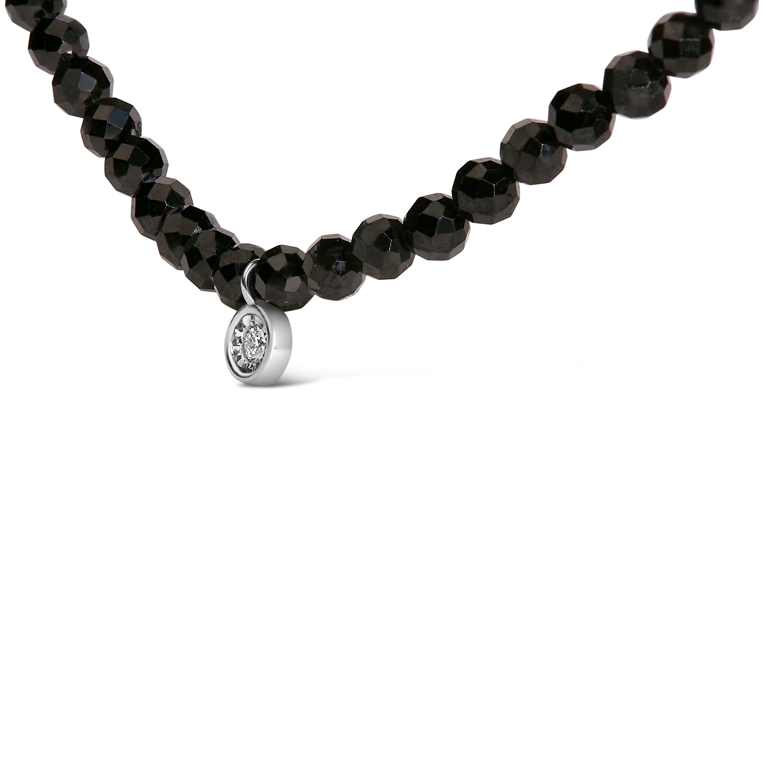 Black beaded necklace with a silver pendant on a white background