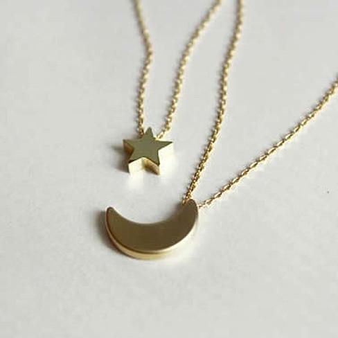 Golden Moon and Star Charms on a Layered Chain Necklace