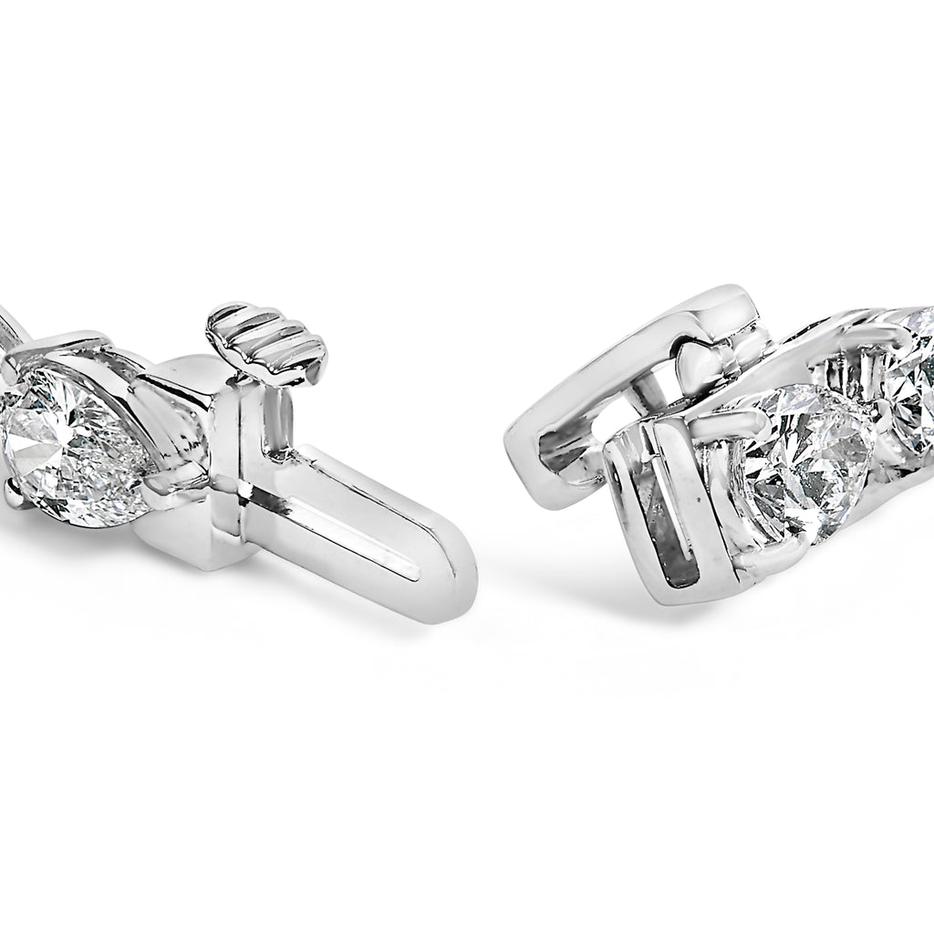 Close-up of two diamond earrings on a white background