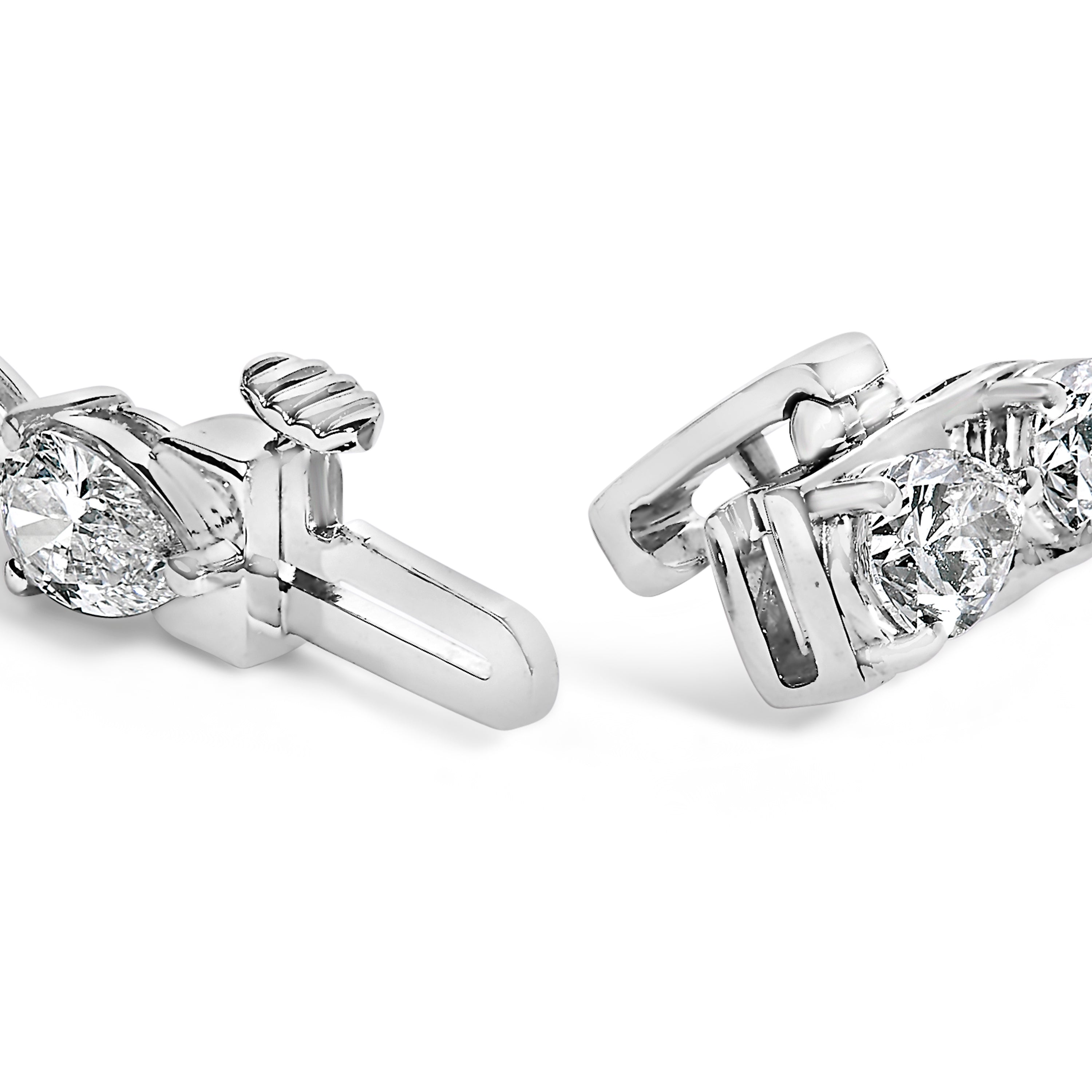 Close-up of two diamond earrings on a white background