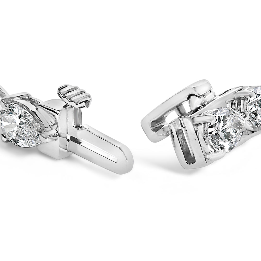 Close-up of two diamond earrings on a white background