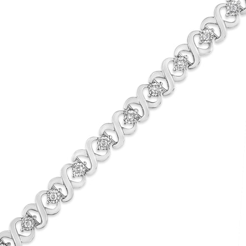 Silver bracelet with diamond accents on a white background