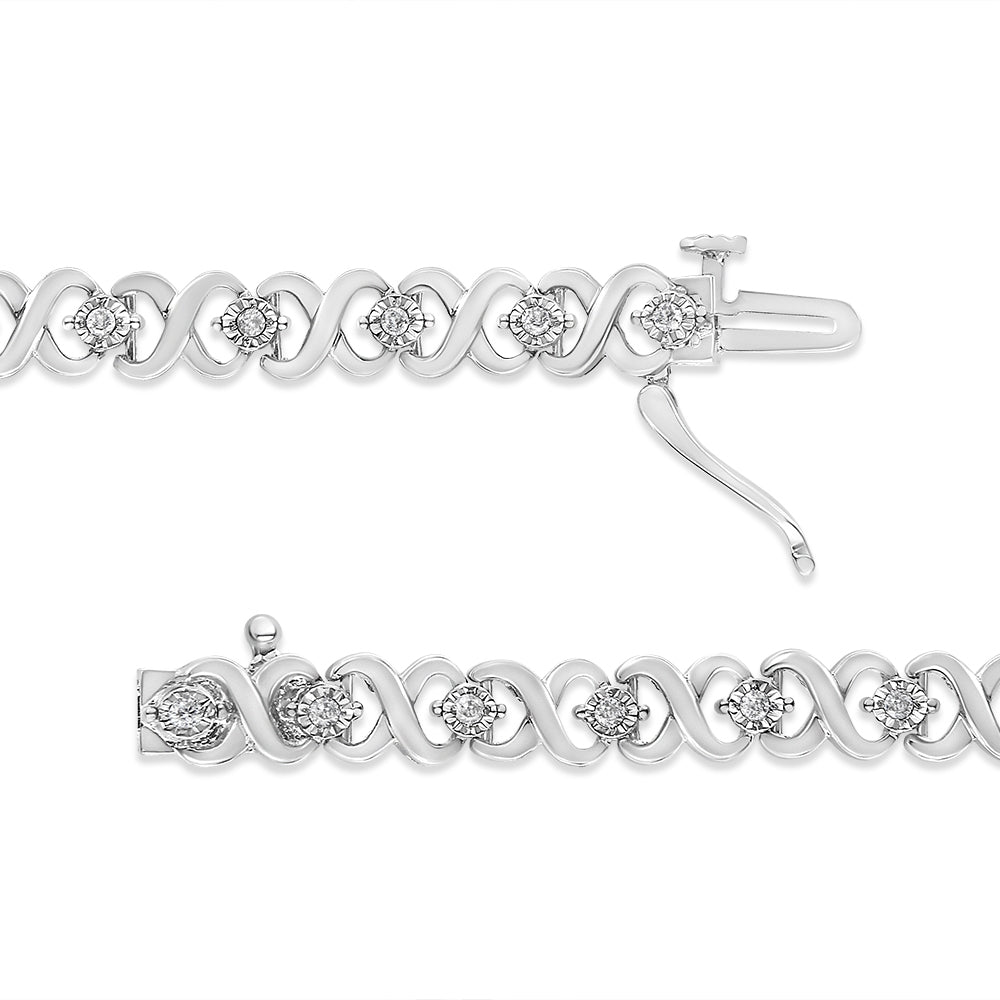 Silver bracelet with diamond accents on a white background