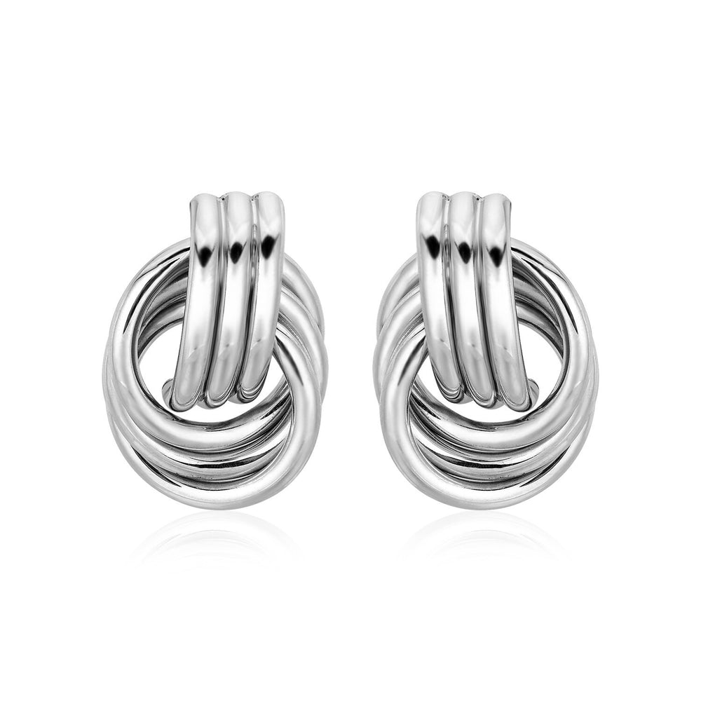 Pair of silver knot earrings on a white background