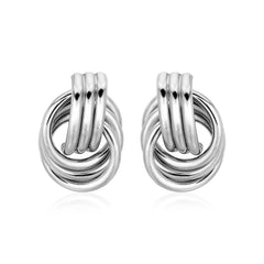 Pair of silver knot earrings on a white background