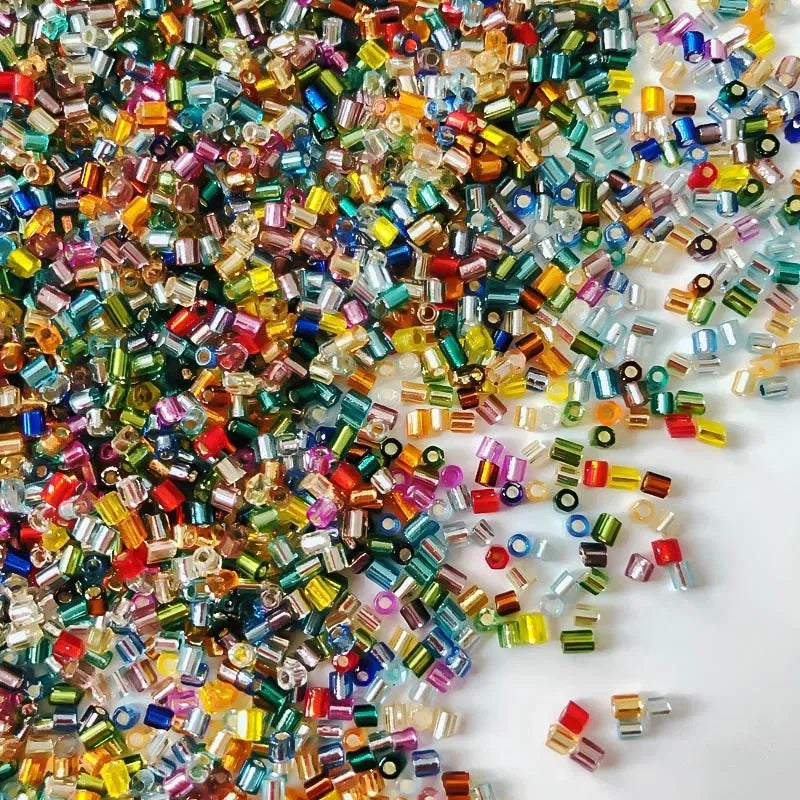 Multicolored beads scattered on a white background