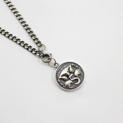 Silver chain necklace with a fox pendant on a light gray background