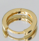 Gold hoop earrings on a plain background