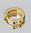Gold earring with green gemstone on a white background