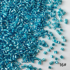 Turquoise glass beads scattered on a white background