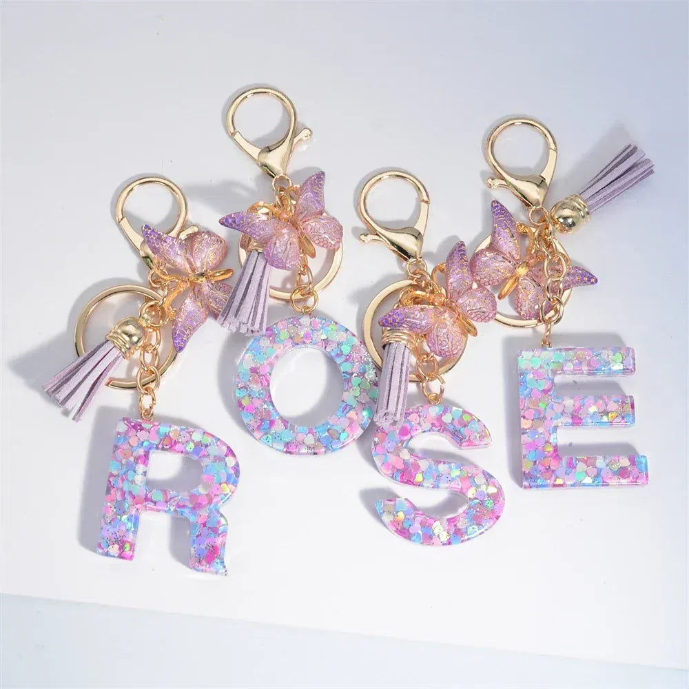 Color: Dark Brown - Fashion Tassel Butterfly 26Letter Keychain Colorful Love Heart Filled Resin Alphabet Keyring Women Girls Car Bag Phone Pendant