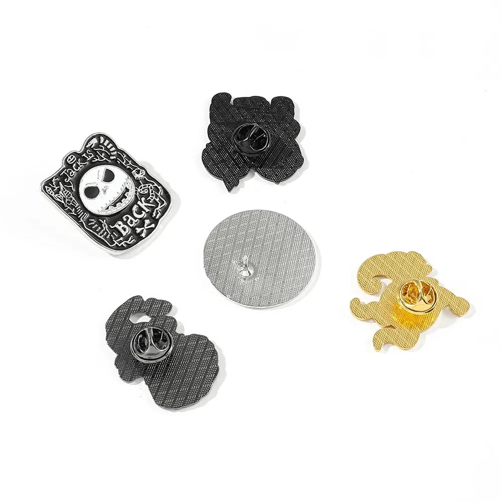 Set of five pins with various designs on a white background