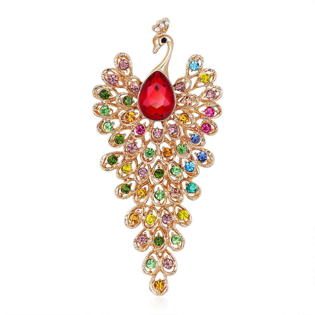 Jewelry brooch shaped like a peacock with colorful gemstones on a white background